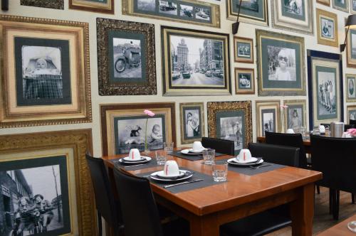 a dining room with a table and pictures on the wall at Hotel Royal Zelzate in Zelzate