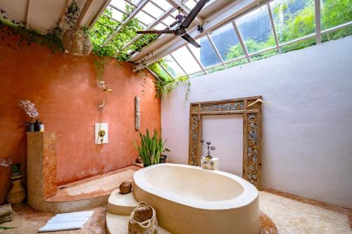 a large bathroom with a large tub and a window at 4BR Villa for Families - 5 Min to Thomas Beach in Ungasan