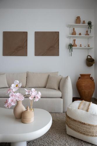 a living room with a white couch and a white coffee table at Desert Retreat Canal View walk to F1 Yas Island in Abu Dhabi