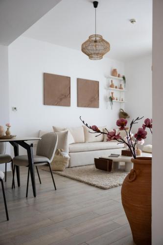 a living room with a white couch and a table at Desert Retreat Canal View walk to F1 Yas Island in Abu Dhabi