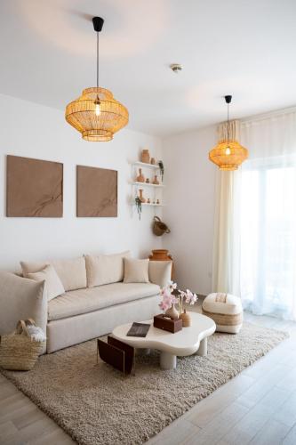 a living room with a white couch and a coffee table at Desert Retreat Canal View walk to F1 Yas Island in Abu Dhabi