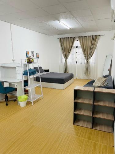 a bedroom with a bed and a desk and a desk at CozyHouse Korat in Sathani Phu Khao Lat