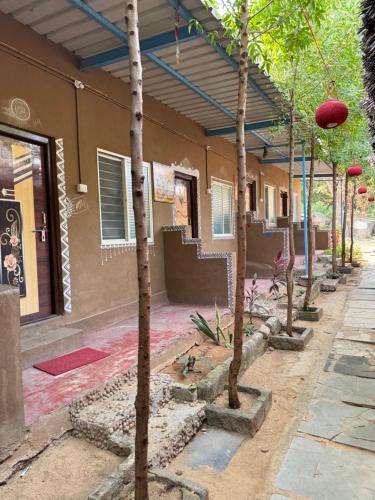 a row of trees in front of a building at Jungle Tree Hampi in Hampi