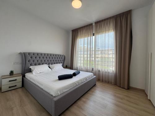 a bedroom with a large bed and a large window at Modern 3 bedroom villa with pool in Paphos City