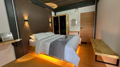 a bedroom with a bed and a wooden floor at Villa Moon Terrace in Bang Khen