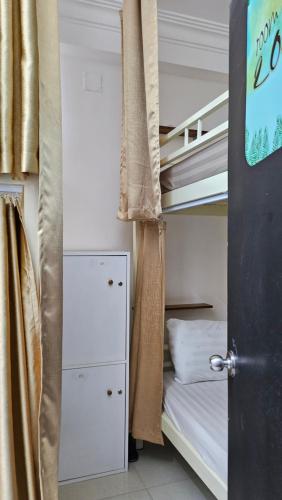 a small bedroom with a bunk bed and a bunk bed at Khoi Hostel in Ho Chi Minh City