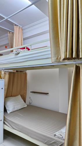 a bunk bed in a room with curtains at Khoi Hostel in Ho Chi Minh City