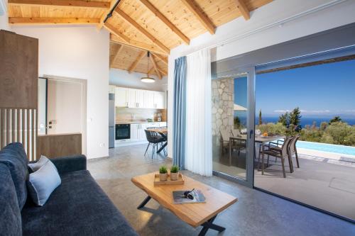 a living room with a blue couch and a table at Ionian Harmony in Tsoukaladhes