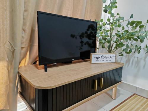 a flat screen tv sitting on top of a tv stand at Suite U Studio 108 in Kota Bharu