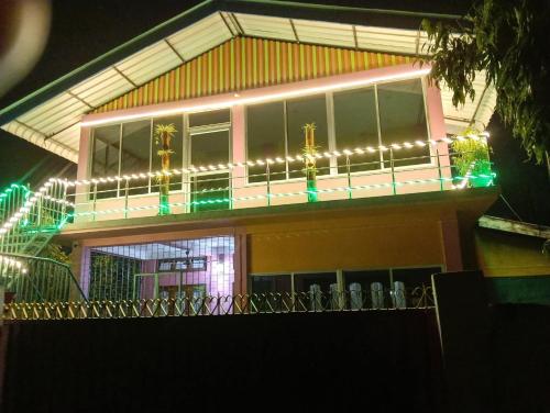 a building with christmas lights on top of it at Mayabini The Village Homestay in Bindukuri