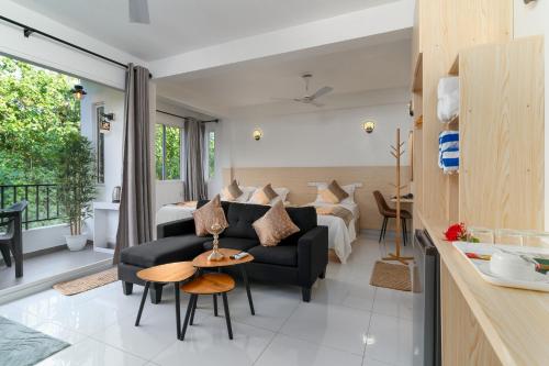 a living room with a couch and a table at La Sky Stay in Ukulhas