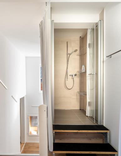 a bathroom with a walk in shower in a room at Comfy, Spacious and Central Duplex Apartment in Zweisimmen