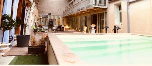 una piscina en medio de un edificio en cosy studio dans une maison d'hôte, en Bourg-en-Bresse