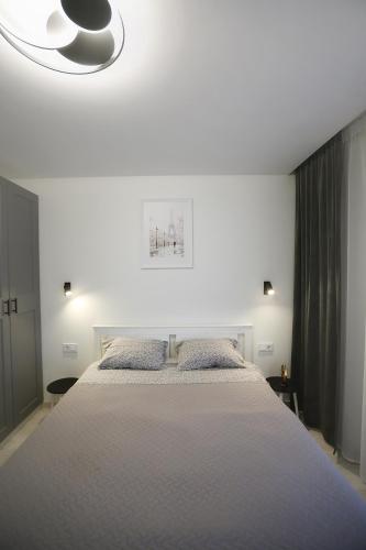 a bedroom with a large bed with two pillows at Gargždai, Lithuania in Gargždai
