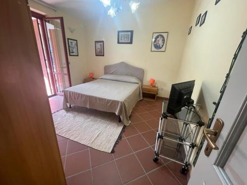 a bedroom with a bed and a tv in it at A casa di Mariarosaria in Pozzovetere