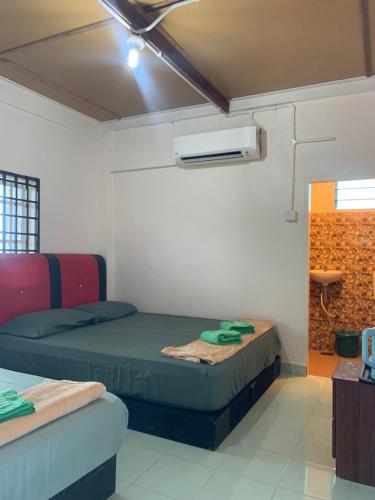a room with two beds and a air conditioner at Anis View Chalet in Perhentian Island