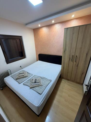 a bedroom with a bed and a wooden cabinet at Apartman Stefan Zlatibor in Zlatibor