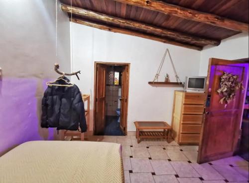 a room with a table and a dresser and a room at Wonderful Full House in Ollantaytambo