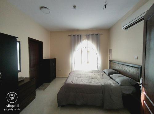 アル・アインにあるSolo comfort 205の大きなベッドと窓のある寝室