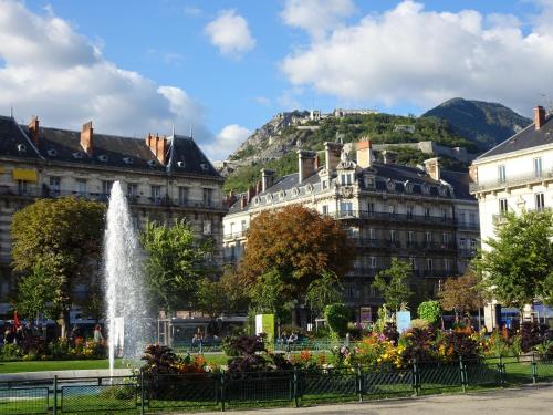 a fountain in a park in front of buildings at Studio place Victor Hugo in La Celle-sous-Gouzon