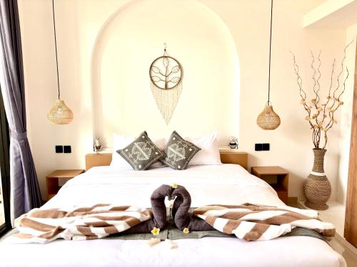 a bedroom with a bed with blankets and pillows at D'rei guesthouse in Canggu