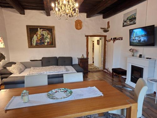 a living room with a couch and a table at Appartement Donaustrand in Bergern