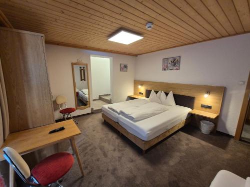 a bedroom with a large bed and a wooden ceiling at Apart Lenz in Ischgl