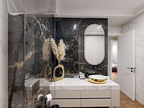 a bathroom with a sink and a mirror at Ideal Apartments in Banja Luka