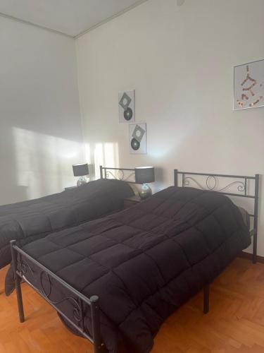 a bedroom with two beds in a room at Tamika's House in Udine