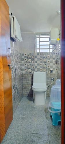 a bathroom with a toilet and a shower at Hotel Propel Inn in Dobbspet