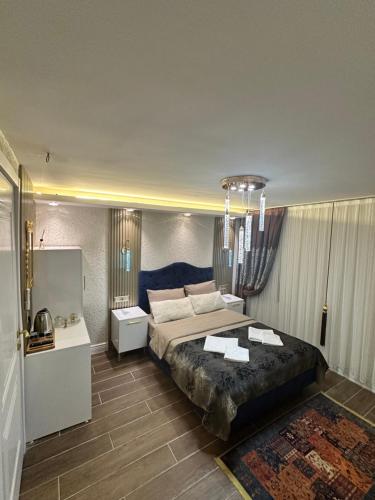 a bedroom with a large bed with a blue headboard at TH Old City Hotel in Istanbul