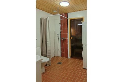 a bathroom with a shower and a toilet at Kotimaailma Woody 3 in Lahti