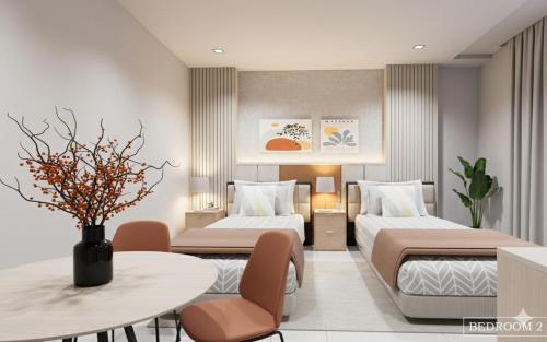 a hotel room with two beds and a table at Suchanan Serviced Apartment โรงแรมสุชานันท์ in Ban Chang