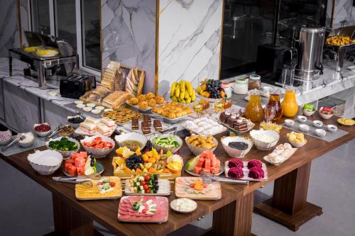 a table filled with lots of different types of food at Floranta Hotel in Qarshi