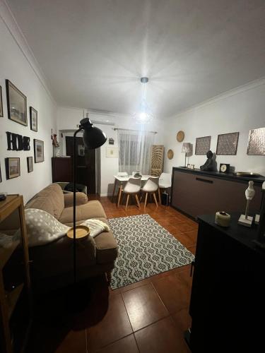 a living room with a couch and a table at Juniors Country House in Vila Boim