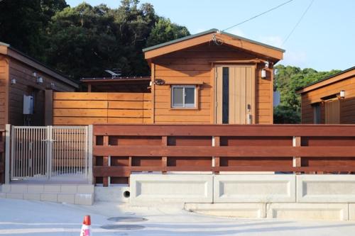 a wooden house with a fence and a gate at La prima stella - Vacation STAY 54161v in Nakasone