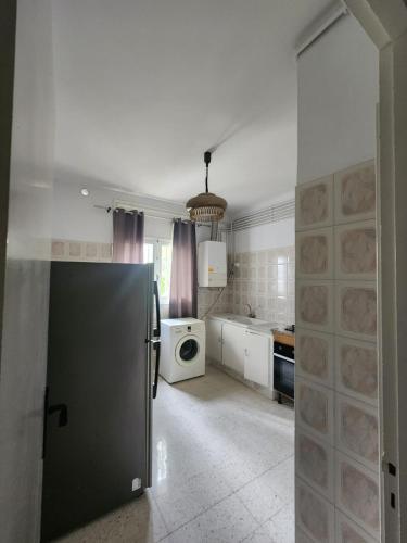 a kitchen with a refrigerator and a microwave at Manar Clinique House in Tunis