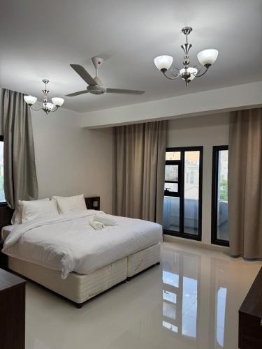 a bedroom with a bed and a ceiling fan at Qala View Inn in Nizwa