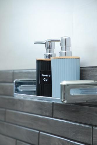 a shower cat dispenser sitting on top of a counter at Moon&Back Homestay in Galle