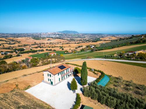 an aerial view of a house in a field at Il Grande Cipresso B&B in Castelnuovo