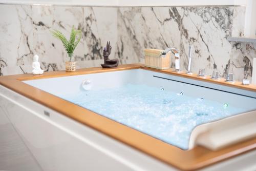 a bath tub with a sink in a bathroom at Villa La Torre in San Giuliano Terme