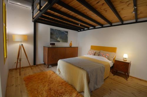 a bedroom with a large bed and a wooden ceiling at Agapi in Kissamos