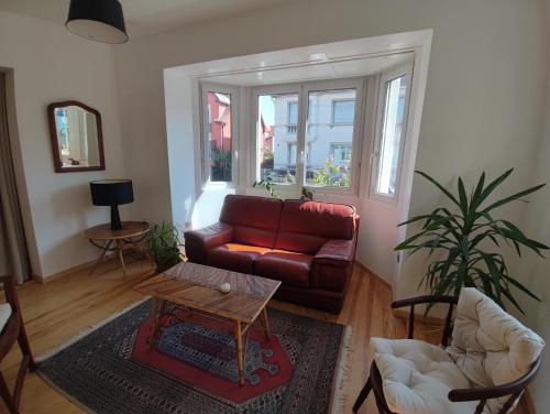 a living room with a couch and a table at Charme et authenticité pour 4 personnes 