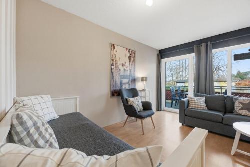 a living room with a bed and a couch at Fewo Henri in Zempin