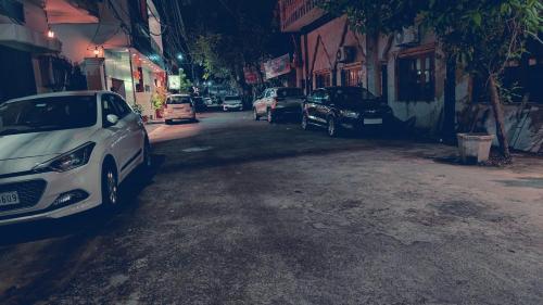 a white car parked on the side of a street at Hotel Pilgrim Near Golden Temple in Amritsar