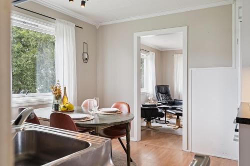 a kitchen and dining room with a sink and a table at House in the middle of Lofoten - Leknes in Leknes