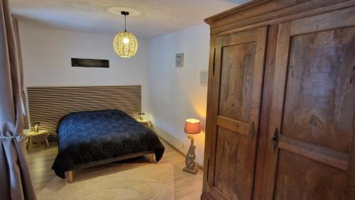 a bedroom with a bed and a wooden door at La vita è bella in Sélestat