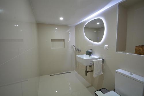 a white bathroom with a sink and a mirror at Agapi in Kissamos
