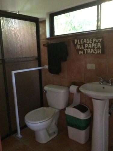 un baño con inodoro y lavabo en Jodokus Inn, en Montezuma