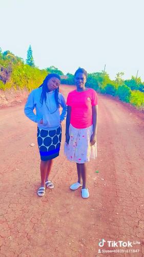 two women are standing on a dirt road at Maureen Homes Bomet in Bomet